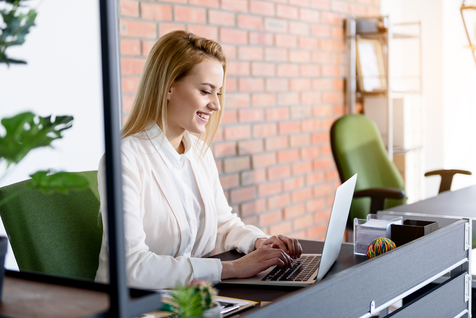 Cheerful girl typing on computer